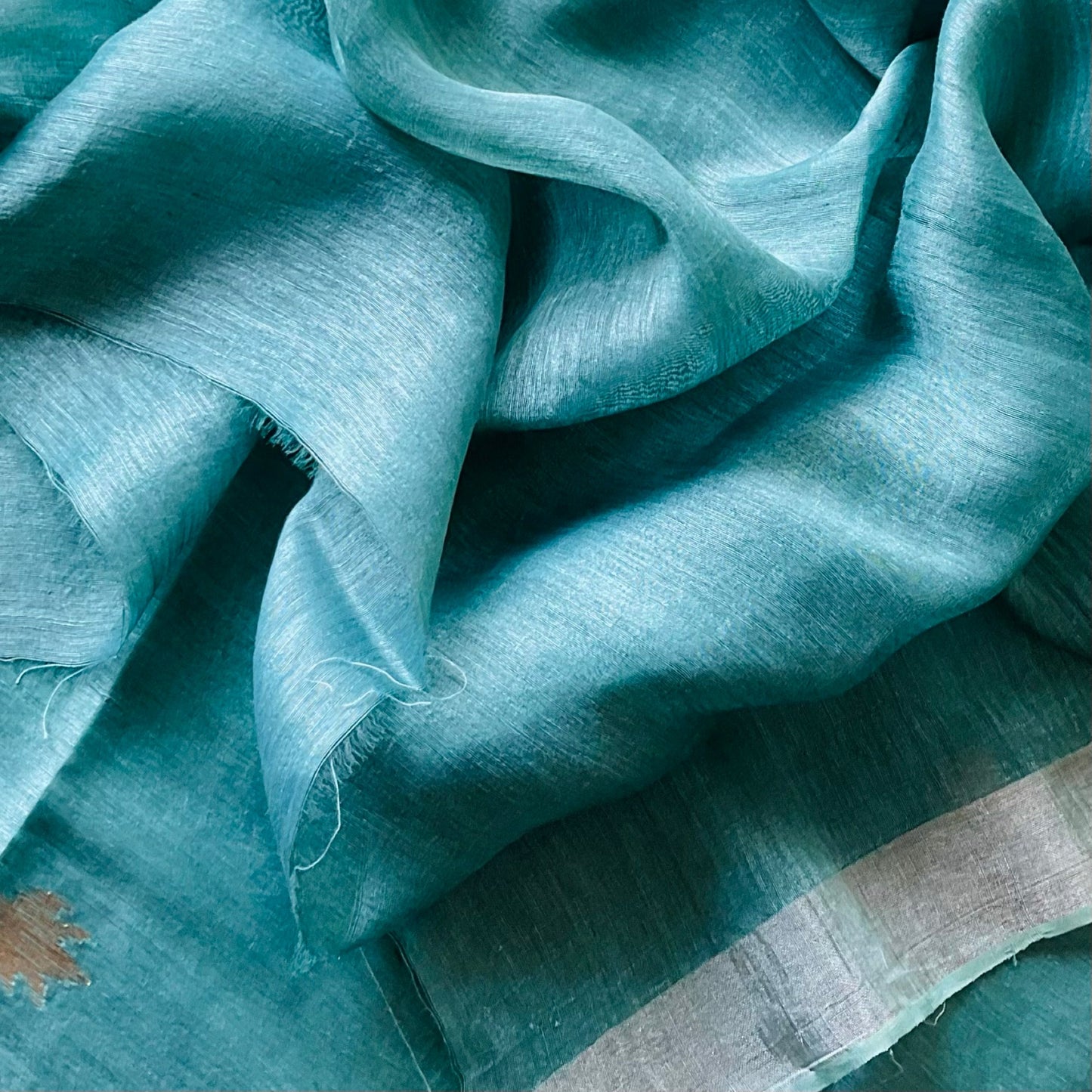 Linen silk green saree with same colour plain blouse with zari border.