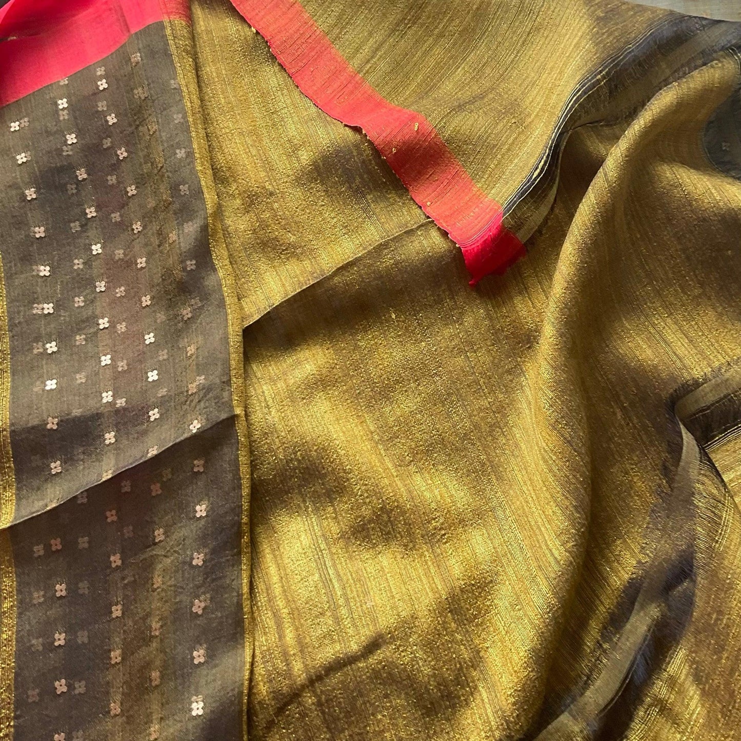 Contemporary festive wear olive green muslin silk saree with red borders, all-over modern pocket sequins, and a rustic Matka silk blouse.